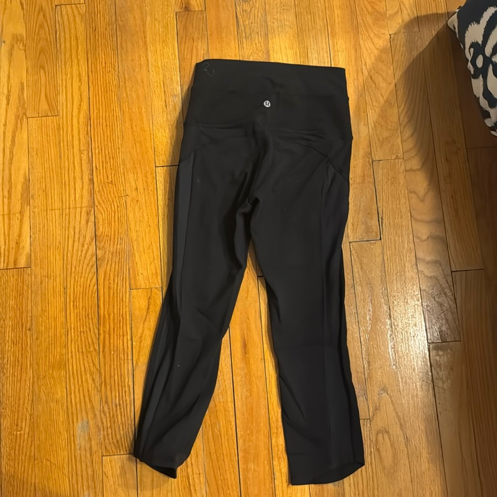 Cropped black lululemon leggings with pattern down the side